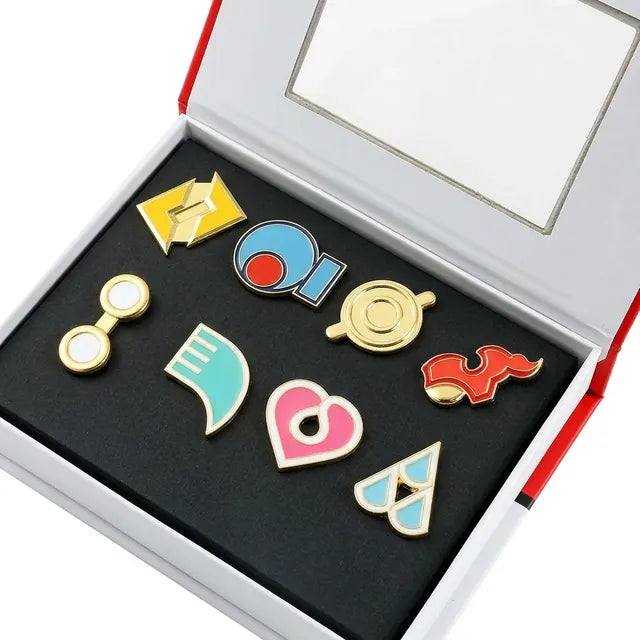 Hoenn gift box open, eight enamel badges in two rows on black foam