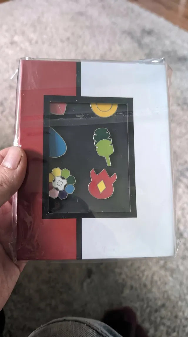 A closed gift box as it arrived, badges visible through the window