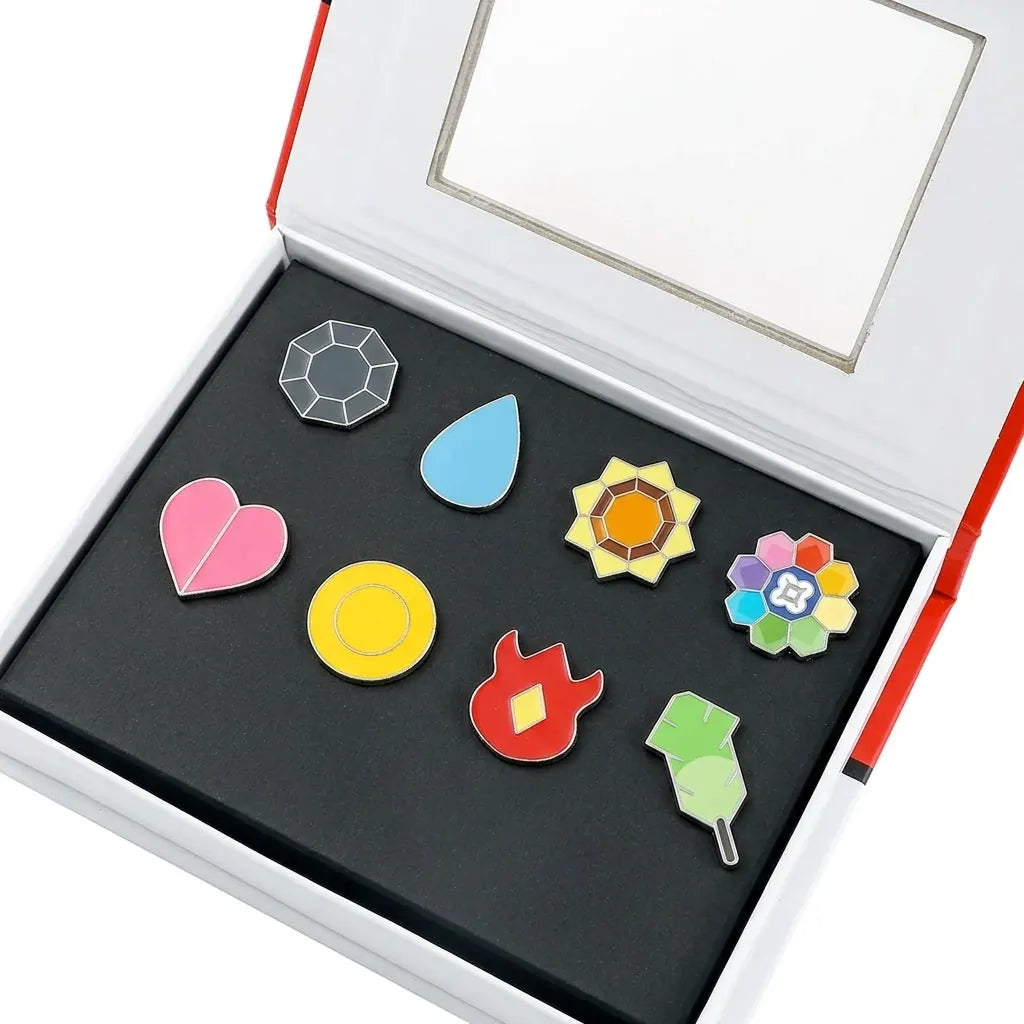 Kanto gift box open, eight enamel badges in two rows on black foam